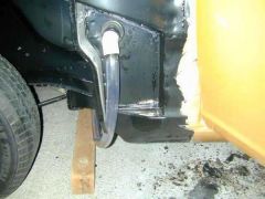 In this picture the hose and PVC corner are how I re-directed the drain hose OUT of the car's fender plenum.